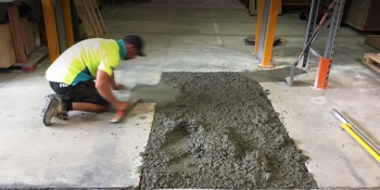 Man repairing concrete.