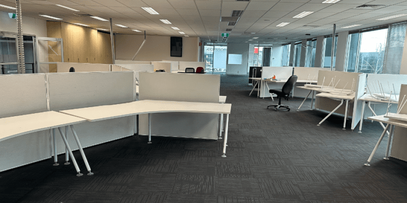 An office with a new fit-out. Desks are assembled but no chairs are present yet.