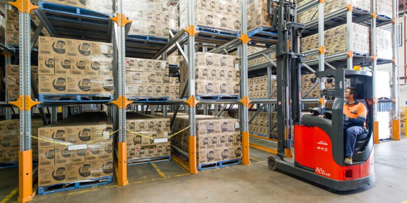 Forklift using drive in pallet racking.