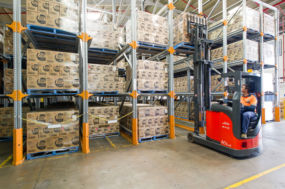 Forklift using drive in pallet racking.
