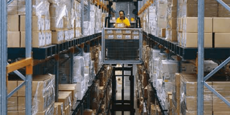 Narrow aisle pallet racking filled with pallets and boxes.