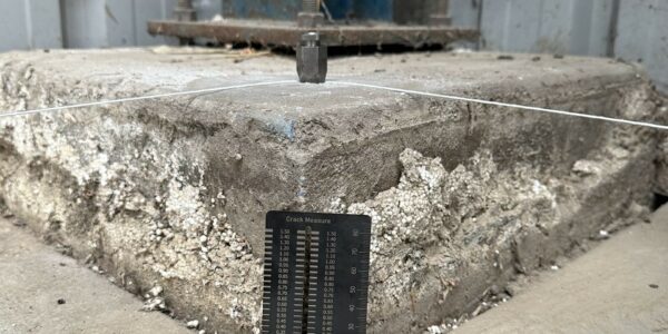 Ruler showing how much a concrete slab has subsided.